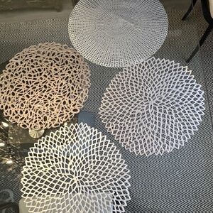 Chilewich place setting, laser-cut, perforated, organic shapes, in silver.